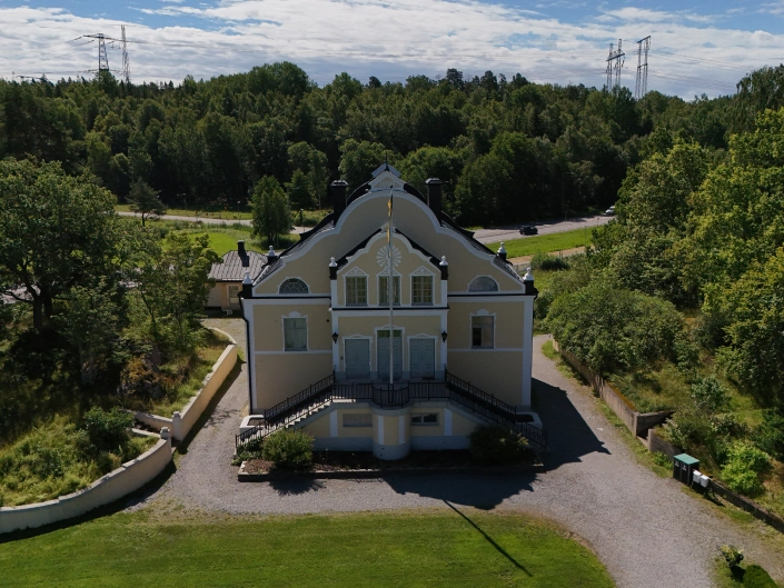 Vy över en gul villa i Hågelby Park.