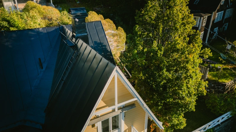 Yellow villa with black roof.